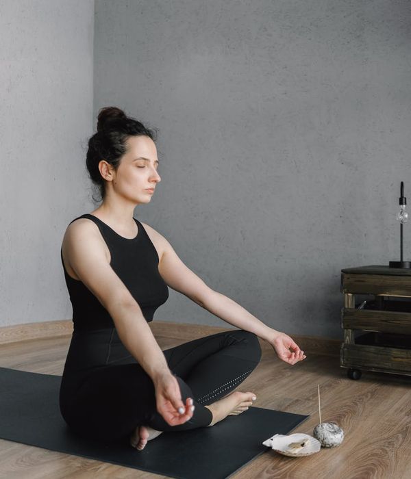 Woman feeling energized and happy in a bright living room.